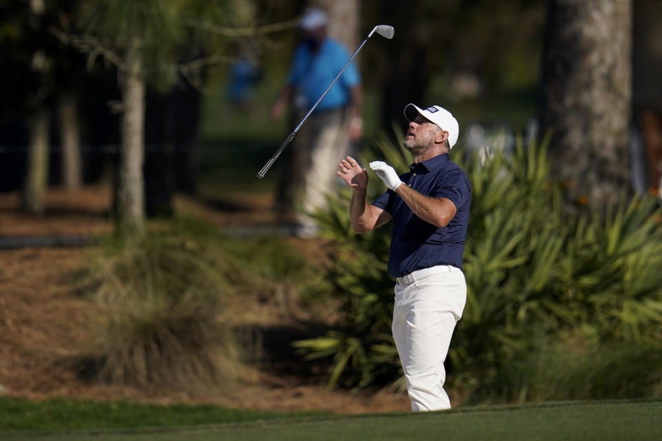 Lee Westwood, of England, tosses his club after a bunker shot on the 15th hole during the final round of The Players Championship golf tournament Sunday, March 14, 2021, in Ponte Vedra Beach, Fla. (AP Photo/Gerald Herbert)