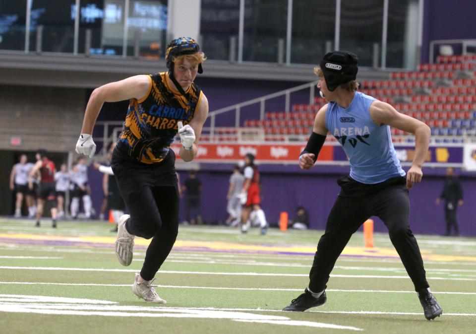 Raif Jensen (0), left, runs a route during a 7-on-7 football tournament Saturday at the UNI-Dome in Cedar Falls.