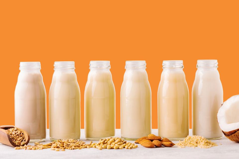 A bottles of alternative milk on an orange background