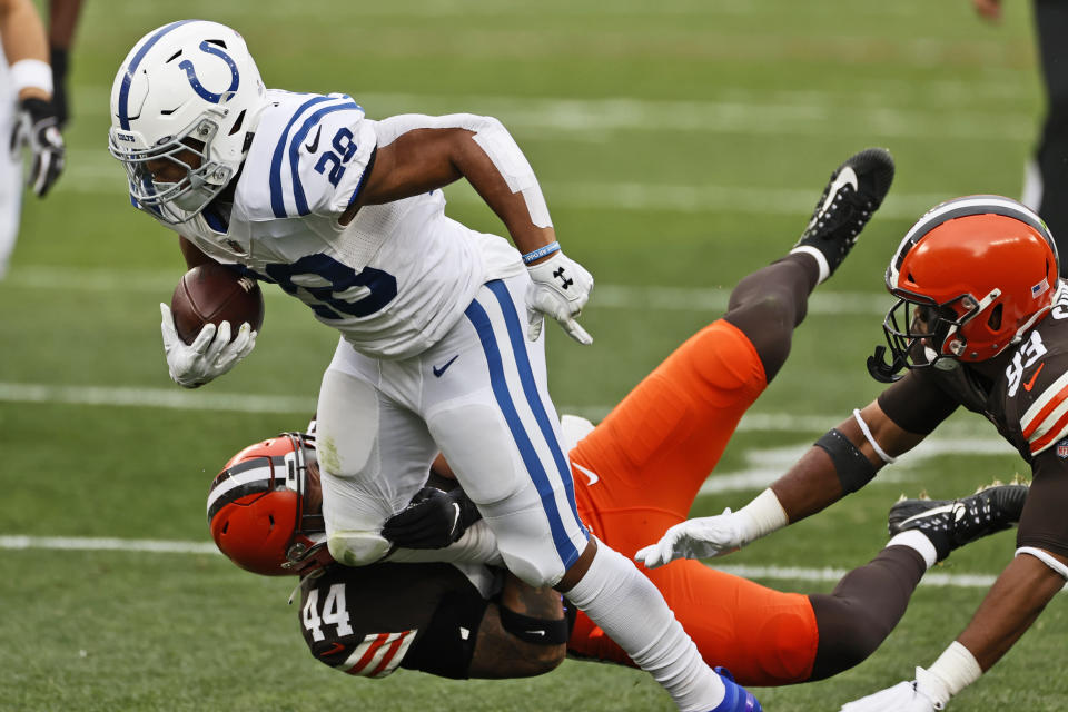 Indianapolis Colts running back Jonathan Taylor (28) tries to break a tackle from Cleveland Browns linebacker Sione Takitaki (44) during the first half of an NFL football game, Sunday, Oct. 11, 2020, in Cleveland. (AP Photo/Ron Schwane)