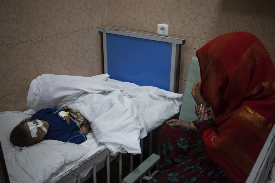 Walima looks at her son Khalil, 1 year old, who is malnourished, in the Indira Gandhi hospital in Kabul, Afghanistan on Monday, Nov. 8, 2021. The number of people living in Afghanistan in near-famine conditions has risen to 8.7 million according to the World Food Program. (AP Photo/Bram Janssen)