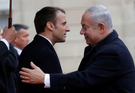 French President Emmanuel Macron and his wife Brigitte Macron welcome Israel Prime Minister Benjamin Netanyahu and his wife Sara at the Elysee Palace as part of the commemoration ceremony for Armistice Day, 100 years after the end of the First World War, in Paris, France, November 11, 2018. REUTERS/Philippe Wojazer