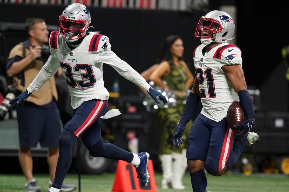 New England Patriots safety Adrian Phillips (21) runs for a touchdown after his interception against the Atlanta Falcons during the second half of an NFL football game, Thursday, Nov. 18, 2021, in Atlanta. The New England Patriots won 25-0. (AP Photo/Brynn Anderson)