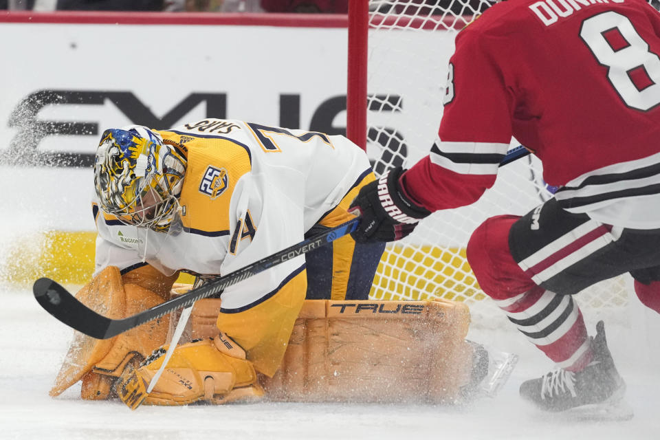 Nashville Predators goaltender Juuse Saros makes a save against Chicago Blackhawks center Ryan Donato during the second period an NHL hockey game Tuesday, Dec. 5, 2023, in Chicago. (AP Photo/Erin Hooley)