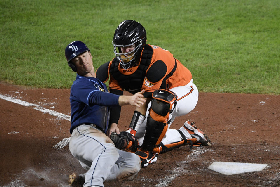 Tampa Bay Rays' Joey Wendle, left, is tagged out at home by Baltimore Orioles catcher Chance Sisco during the fourth inning of a baseball game Saturday, Sept. 19, 2020, in Baltimore. (AP Photo/Nick Wass)