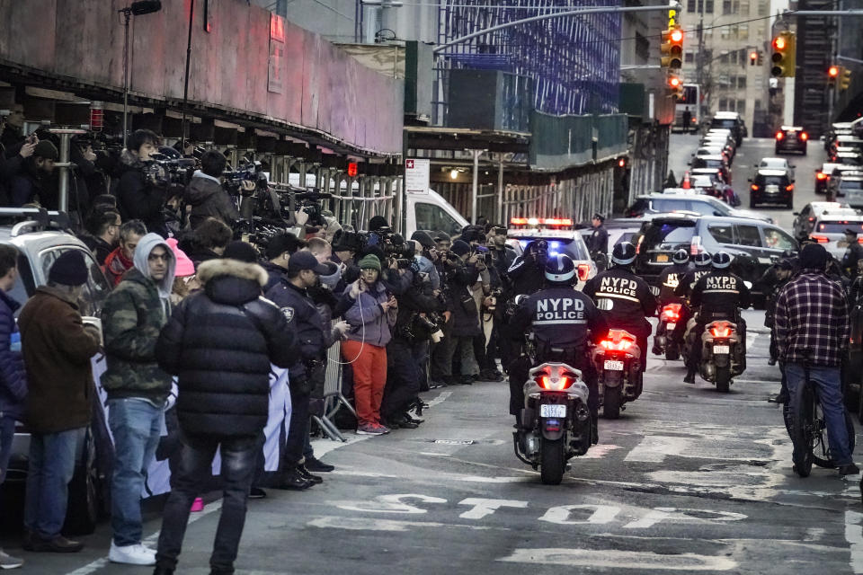 Journalists gather as an NYPD motorcycle patrol arrives for added security outside Manhattan's district attorney's office in New York on Thursday March 30, 2023, after a grand jury investigating hush money payments made to women during Donald Trump's 2016 campaign voted to indict the former president. (AP Photo/Bebeto Matthews)