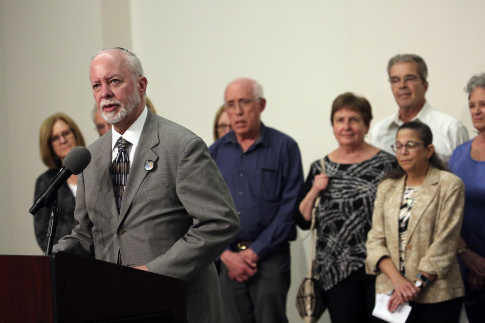 Rabbi Jeffrey Myers speaks to the media surrounded by victims and families of victims following the sentencing of Robert Bowers at the Jewish Community Center in Pittsburgh, Wednesday, Aug 2, 2023. Bowers was sentenced to death for killing 11 people at the Tree of Life synagogue in Pittsburgh in 2018. (AP Photo/Rebecca Droke)
