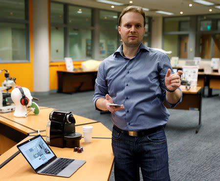 CEO of Unified Inbox Toby Ruckert demonstrates how he uses his smartphone to control electrical appliances in a simulation software in Singapore March 3, 2017. REUTERS/Edgar Su