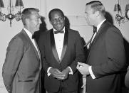 FILE - Green Bay Packers' Willie Davis, center, is flanked by Bart Starr, left, and Chicago Bears' Mike Pyle, right, at an awards dinner in Chicago, July 9, 1967. There are 33 players from HBCUs in the Pro Football Hall of Fame, but many of them played during their halcyon days in the 1960s and ‘70s. That's when Eddie Robinson's juggernaut at Grambling State was producing future Packers star Willie Davis, Bears offensive tackle Ernie Ladd and Buck Buchanan, whom the Chiefs picked first overall in the 1963 AFL draft. (AP Photo/Charles Harrity, File)