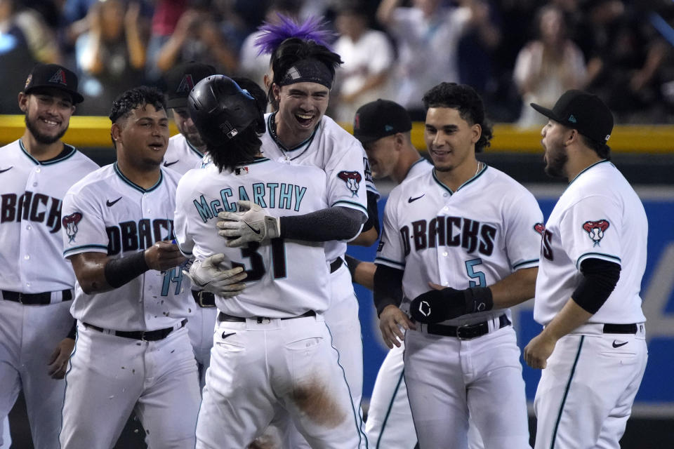 Arizona Diamondbacks' Corbin Carroll, center right, celebrates with Ketel Marte (4), Jake McCarthy (31), Lourdes Gurriel Jr. (12), and Alek Thomas (5) after hitting a walkoff RBI single against the Pittsburgh Pirates in the 10th inning during a baseball game, Saturday, July 8, 2023, in Phoenix. (AP Photo/Rick Scuteri)