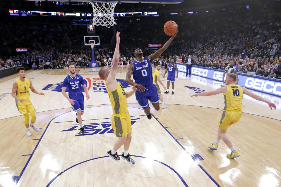 Seton Hall guard Quincy McKnight (0) goes up for a shot against Marquette forward Joey Hauser (22) during the first half of an NCAA college basketball semifinal game in the Big East men's tournament, Friday, March 15, 2019, in New York. (AP Photo/Julio Cortez)