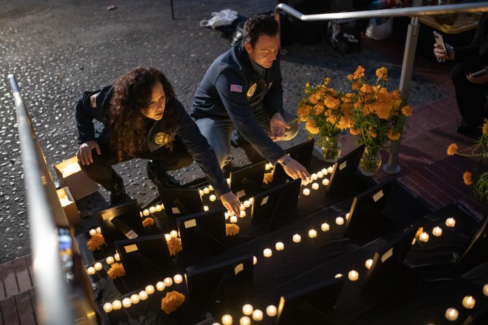 Lorena Gonzalez and Nathan Fletcher kneel at an altar.