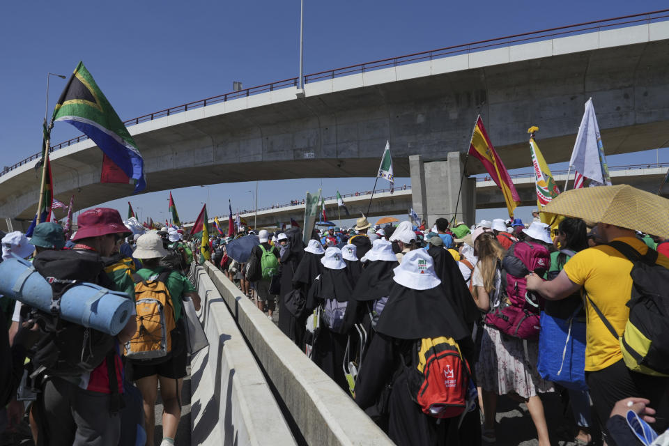 Pilgrims leave Parque Tejo in Lisbon where Pope Francis presided over a mass celebrating the 37th World Youth Day, Sunday, Aug. 6, 2023. An estimated 1.5 million young people filled the parque on Saturday for Pope Francis' World Youth Day vigil, braving scorching heat to secure a spot for the evening prayer and to camp out overnight for his final farewell Mass on Sunday morning. (AP Photo/Ana Brigida)