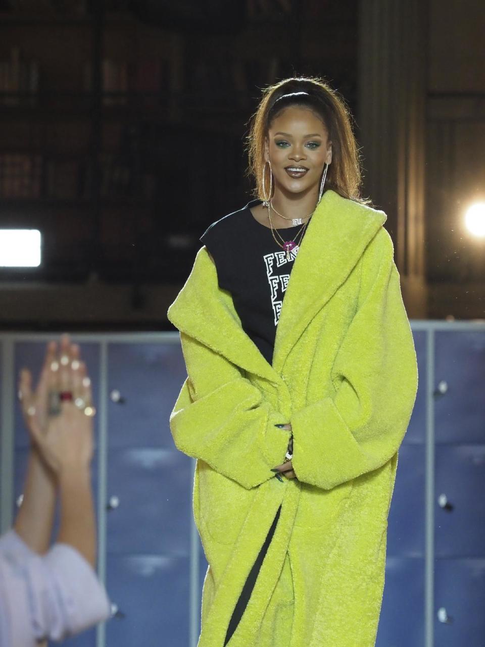 Singer and fashion designer Rihanna acknowledges applause at the end of her Fall-Winter 2017/2018 ready-to-wear collection for Fenty as part of Paris Fashion Week, presented in Paris, Monday March 6, 2017. (AP Photo/Thibault Camus)