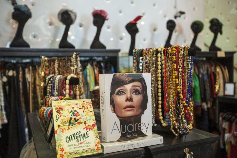 In this photo taken Thursday, Feb. 21, 2013, a 1960's fashion book of actress Audrey Hepburn is displayed with vintage jewelry at "The Way We Wore," a Hollywood high-end vintage store owned by Doris Raymond in the La Brea District of Los Angeles. Raymond's vintage clothing and accessories store is featured in the reality TV series, "L.A. Frock Stars," which debuts March 7, 2013 on the Smithsonian Channel. (AP Photo/Damian Dovarganes)