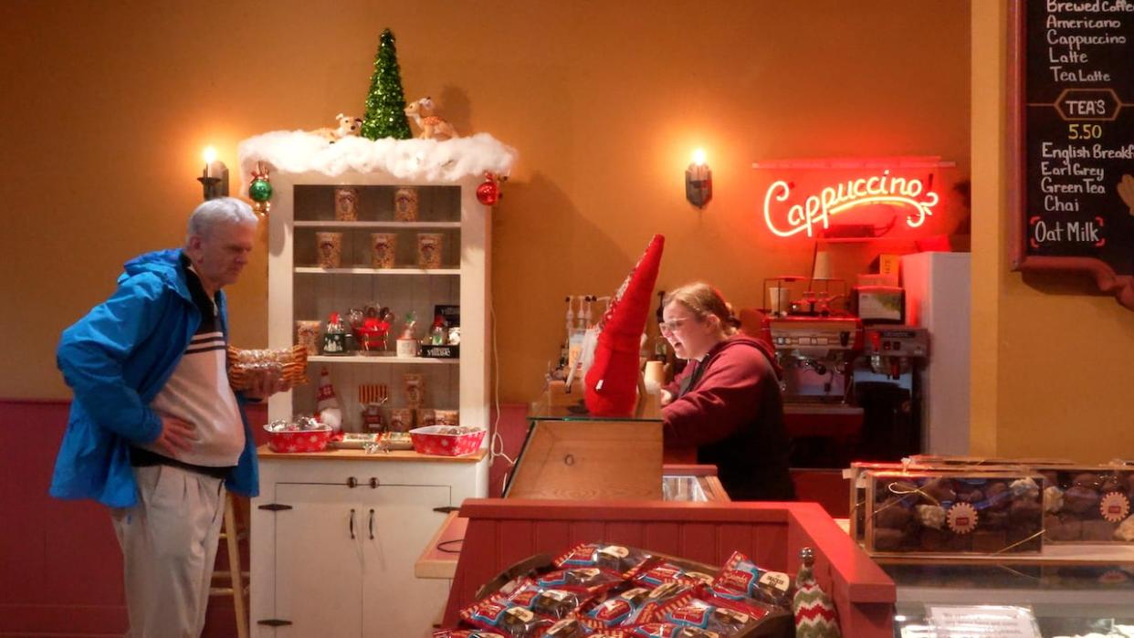 A Coombs Country Candy employee chats with a customer as the Christmas season approaches. (Claire Palmer/CBC - image credit)