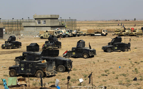 Iraqi forces gather in the area of Taza Khurmata on the southern outskirts of Kirkuk - Credit: AFP