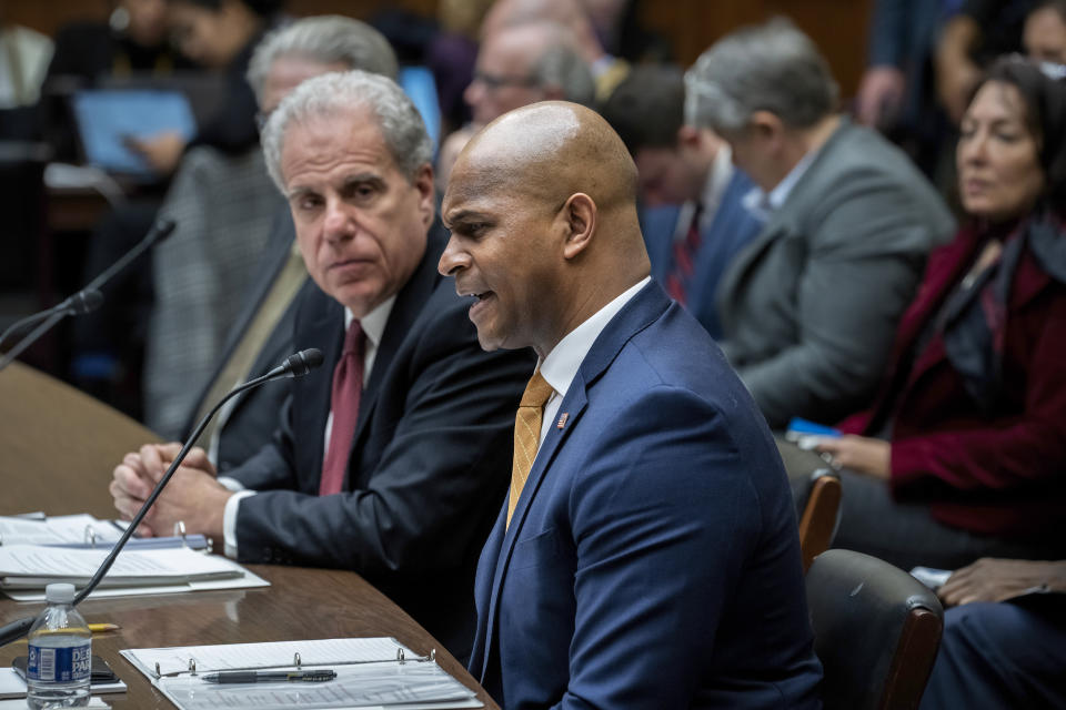 David Smith, center, an assistant director of the Office of Investigations at the U.S. Secret Service, joined at left by Michael Horowitz, who chairs a watchdog panel with oversight of COVID-19 spending, testifies before the House Oversight and Accountability Committee about waste and fraud in COVID-19 relief programs, at the Capitol in Washington, Wednesday, Feb. 1, 2023. (AP Photo/J. Scott Applewhite)