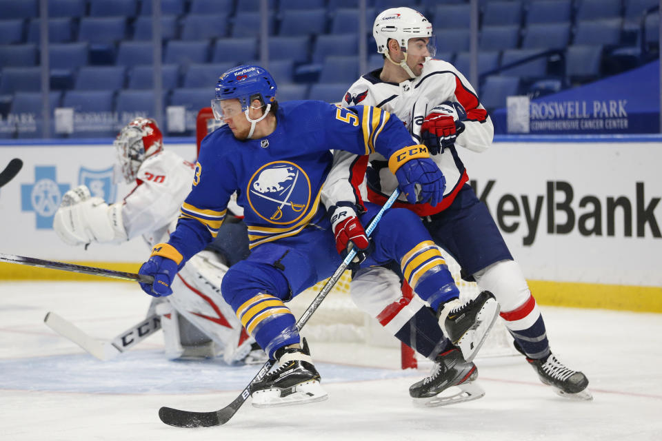 Buffalo Sabres forward Jeff Skinner (53) and Washington Capitals defenseman Justin Schultz (2) vie for position during the second period of an NHL hockey game Thursday, Jan. 14, 2021, in Buffalo, N.Y. (AP Photo/Jeffrey T. Barnes)