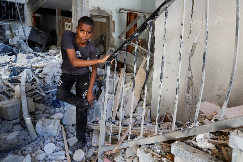 A Palestinian boy stands amidst the rubble at the site of an Israeli air strike in Tulkarm camp, in Tulkarm, in the Israeli-occupied West Bank on Friday (REUTERS)