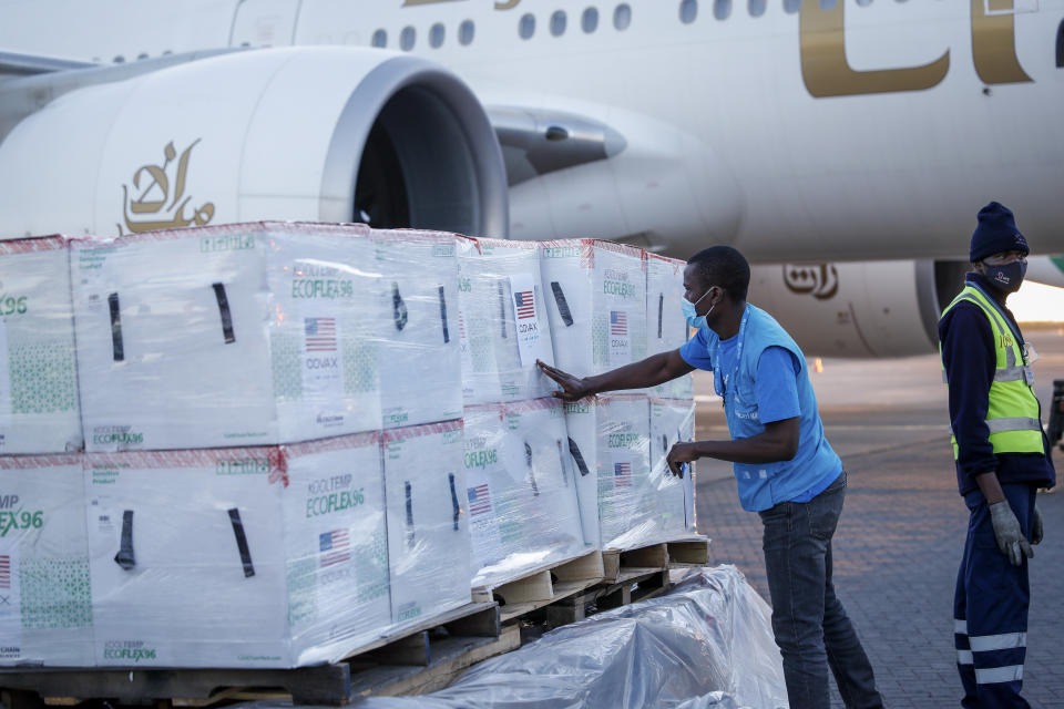 A UNICEF worker checks boxes of Moderna coronavirus vaccine after their arrival at the airport in Nairobi, Kenya Monday, Aug. 23, 2021. The first time that Moderna COVID-19 vaccines have been received in Kenya, 880,460 doses were delivered forming the first of two shipments totalling 1.76 million doses which were donated by the U.S. government via the COVAX facility, according to UNICEF who transported the vaccines. (AP Photo/Brian Inganga)
