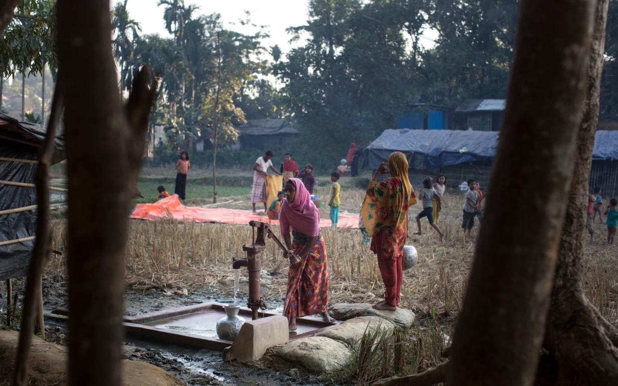 Women collecting water at the Kutupalong refugee camp near Cox's Bazar, Bangladesh - Copyright Â©Heathcliff O'Malley , All Rights Reserved, not to be published in any format without p