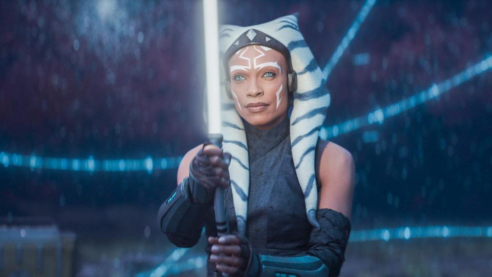  Rosario Dawson as Ahsoka Tano holding a lightsaber in Ahsoka 