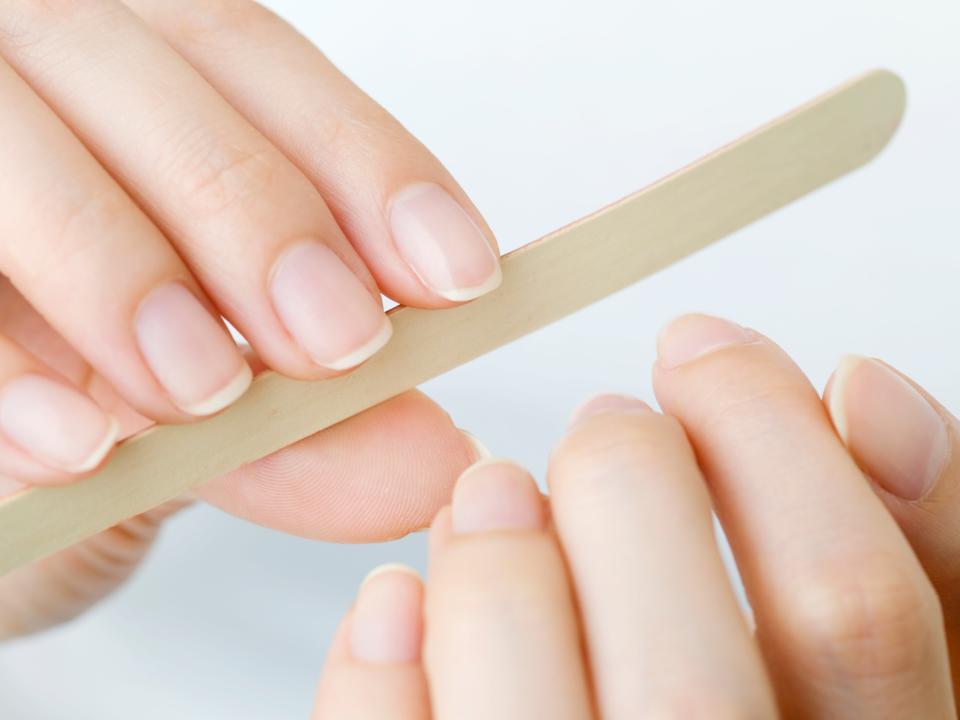 Woman filing nails.