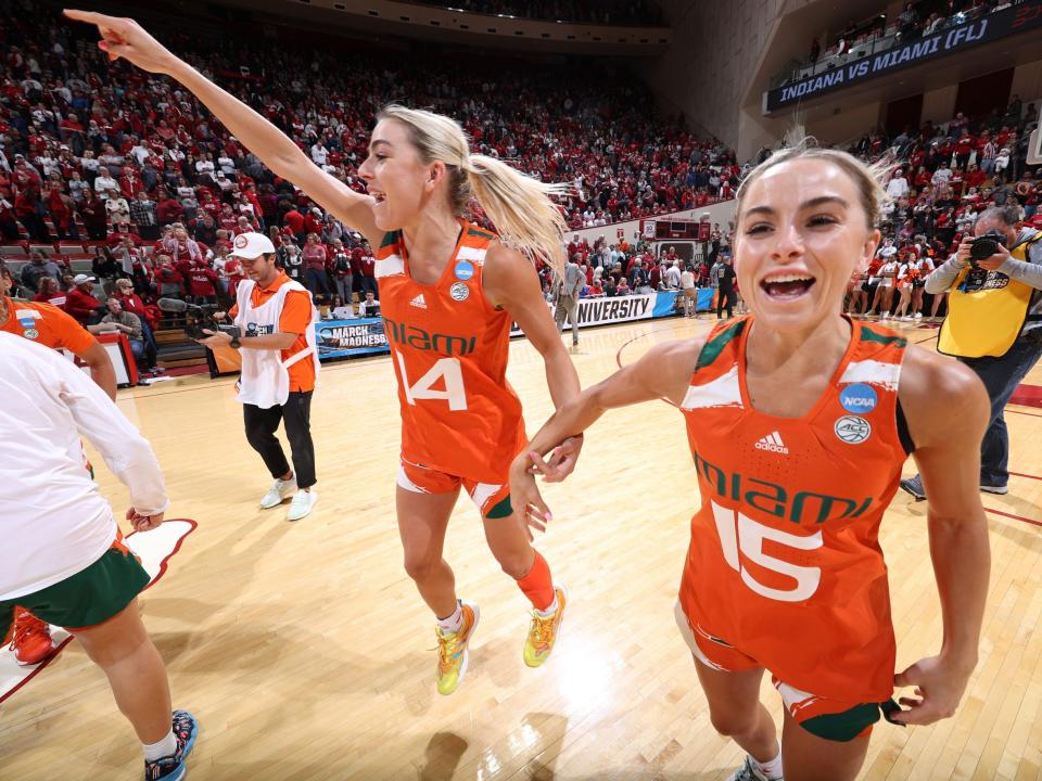 Haley Cavinder and Hanna Cavinder of the Miami Hurricanes celebrate after defeating the Indiana Hoosiers.