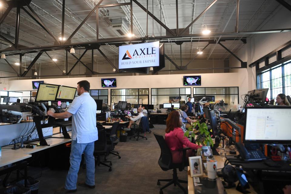 Axle Logistics employees work at the company's Broadway  headquarters on April 25.