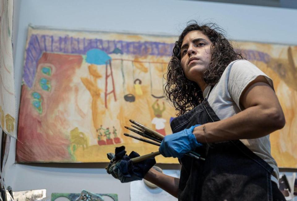 Samantha Rosado surveys a new painting project in her studio at the McColl Center.