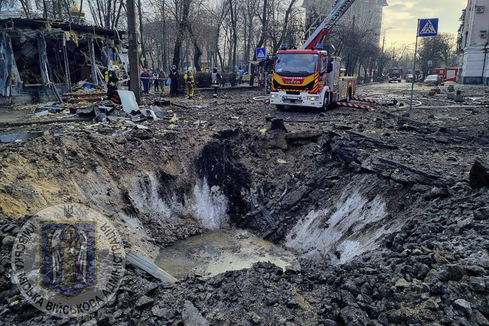 In this photo provided by Serhii Popko, the head of the city's military administration, firefighters work at the site after Russian attacks in Kyiv, Ukraine, Thursday, March 21, 2024. Around 30 cruise and ballistic missiles were shot down over Kyiv on Thursday morning, according Serhii Popko. The missiles were entering Kyiv simultaneously from various directions in a first missile attack on the capital in 44 days. (Serhii Popko, the head of the city's military administration via AP)