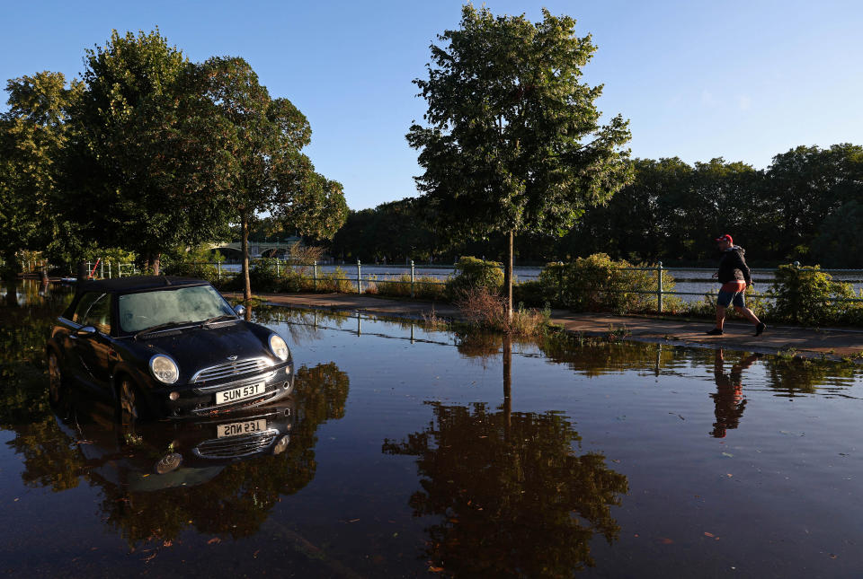 A car is surrounded by water as the River Thames overspills its banks at high tide and in the wake of rainfall from Storm Antoni, London, Britain, August 6, 2023. REUTERS/Toby Melville