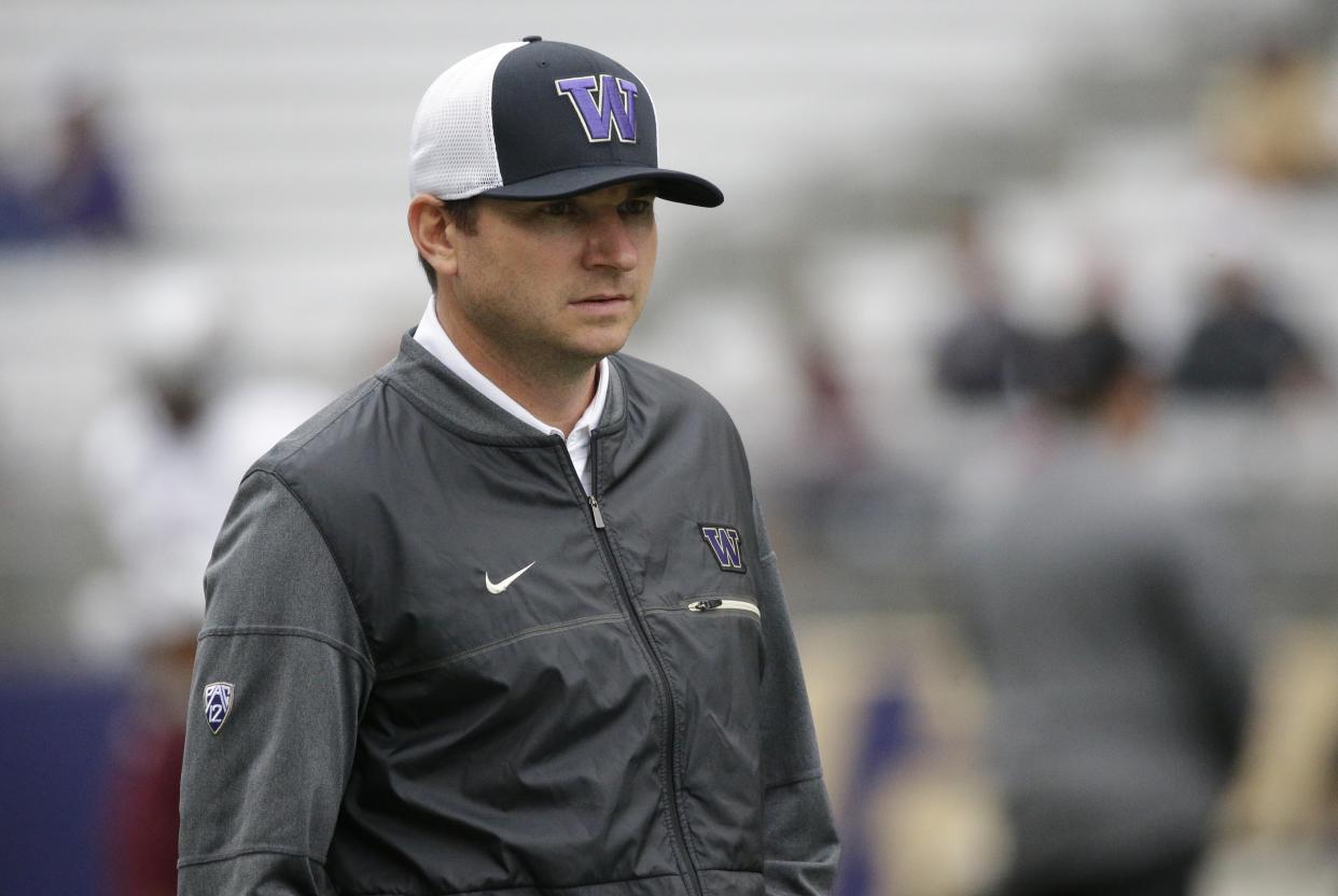 Jonathan Smith, offensive coordinator and quarterbacks coach for Washington, stands on the field during warmups before an NCAA college football game against Montana, Saturday, Sept. 9, 2017, in Seattle. (AP Photo/Ted S. Warren)