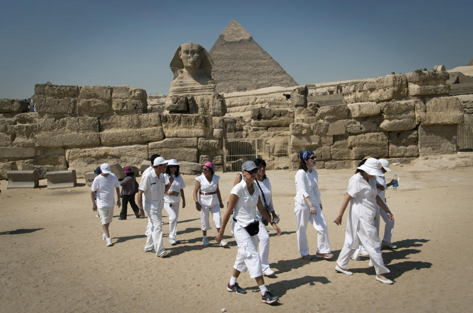 In this Thursday, Sept. 27, 2012 photo, foreign tourists visit the historical site of the Giza Pyramids, near Cairo, Egypt. The Egyptian demonstrations against an online film that was produced by a U.S. citizen originally from Egypt and denigrates the Prophet Muhammad were part of a wider explosion of anger in Muslim countries. They happened near the U.S. Embassy, far from the pyramids of Giza on Cairo's outskirts, and a lot further from gated Red Sea resorts, cocoons for the beach-bound vacationer. Yet the online or TV images _ flames, barricades, whooping demonstrators _ are a killjoy for anyone planning a getaway, even though the protests have largely subsided. Tour guides in Egypt say tourist bookings are mostly holding, but they worry about a dropoff early next year, since people tend to plan several months ahead.(AP Photo/Khalil Hamra)