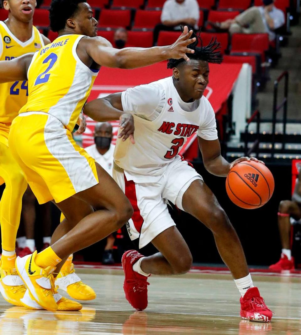 N.C. State’s Cam Hayes (3) drives around Pittsburgh’s Femi Odukale (2) during the second half of N.C. State’s 65-62 victory over Pittsburgh at PNC Arena in Raleigh, N.C., Sunday, February 28, 2021.