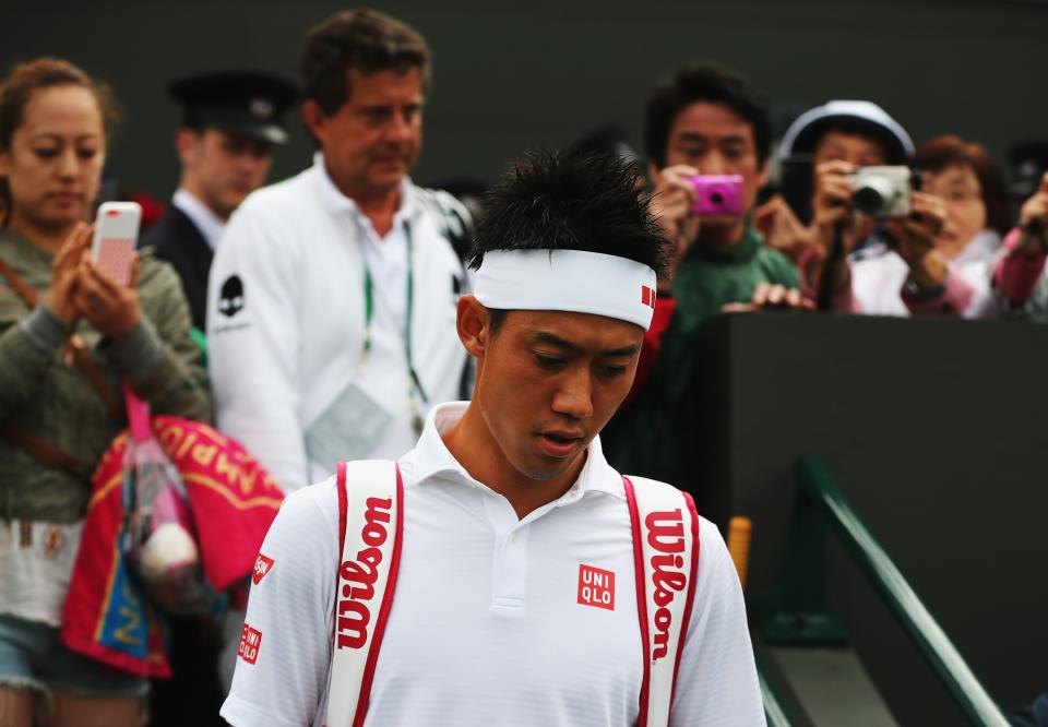 Japan's Kei Nishikori couldn't finish off lucky loser Simone Bolelli Saturday. Deadlocked at 3-3 in the fifth set, they have to return Monday to complete the match. (Photo by Dan Kitwood/Getty Images)