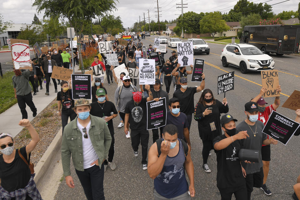 Demonstrators walk in the street during a protest, Saturday, June 6, 2020, in Simi Valley, Calif. over the death of George Floyd.Protests continue throughout the country over the death of Floyd, a black man who died after being restrained by Minneapolis police officers on May 25. (AP Photo/Mark J. Terrill)