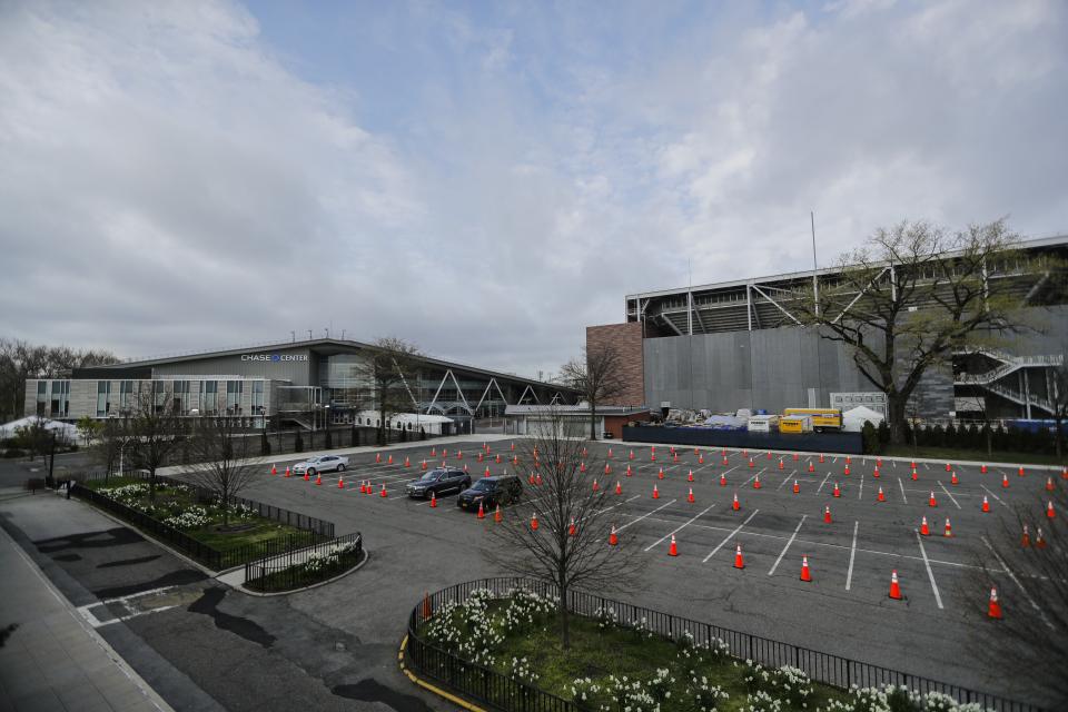 Cones mark the parking lot of the USTA Indoor Training center, Tuesday, April 21, 2020, in the Queens borough of New York. The tennis center has been transformed into a makeshift hospital to help battle the coronavirus. (AP Photo/Frank Franklin II)