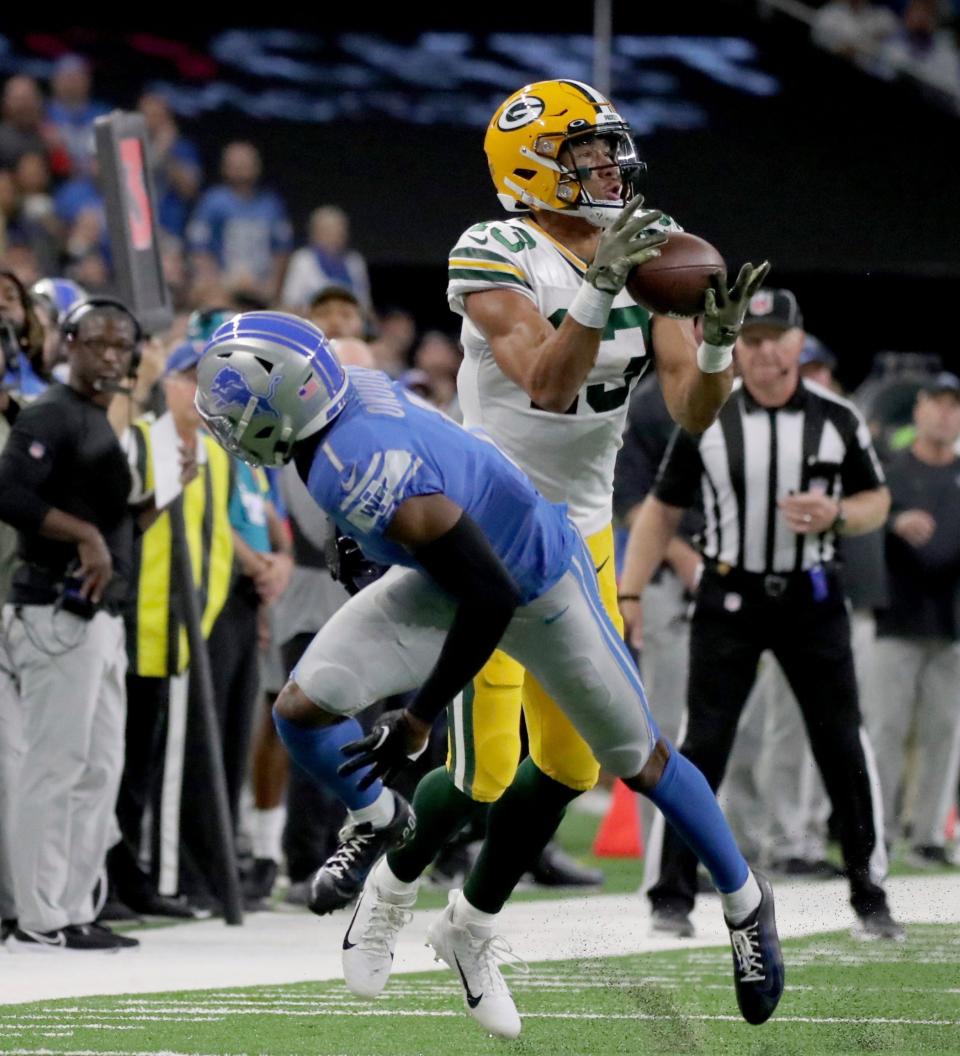 Green Bay Packers wide receiver Allen Lazard makes a catch against Detroit Lions cornerback Jeff Okudah in 2022.