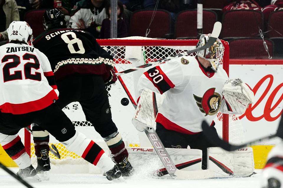 Arizona Coyotes center Nick Schmaltz (8) scores a goal against Ottawa Senators goaltender Matt Murray (30) as Senators defenseman Nikita Zaitsev (22) looks on during the second period of an NHL hockey game Saturday, March 5, 2022, in Glendale, Ariz. (AP Photo/Ross D. Franklin)