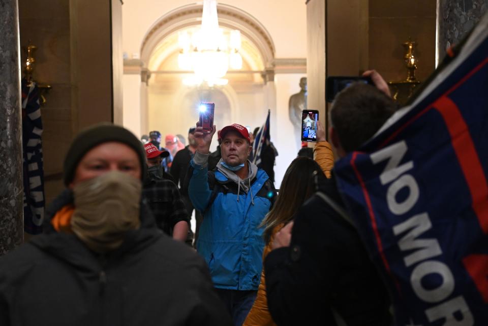 Supporters of US President Donald Trump enter the US Capitol on January 6, 2021, in Washington, DC. - Demonstrators breeched security and entered the Capitol as Congress debated the a 2020 presidential election Electoral Vote Certification. (Photo by Saul LOEB / AFP) (Photo by SAUL LOEB/AFP via Getty Images) ORG XMIT: 0 ORIG FILE ID: AFP_8YA7CH.jpg