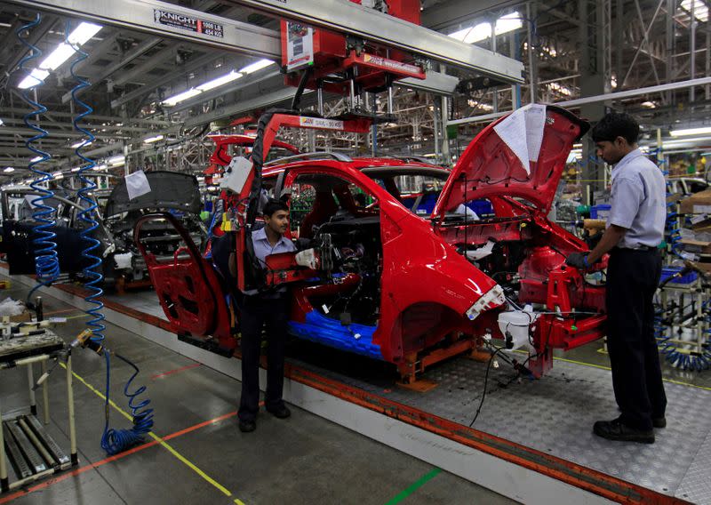 FILE PHOTO: Employees work on a Chevrolet Beat car on an assembly line at the General Motors plant in Talegaon