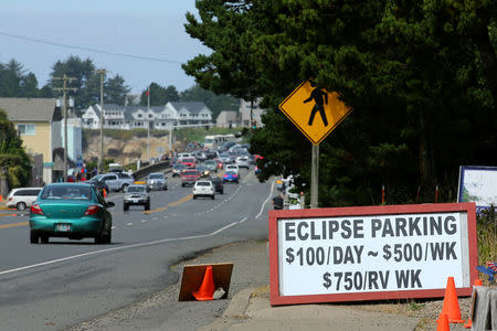An Entrepreneurial sign for parking is displayed for drivers as they near the small town of Depoe Bay, Oregon as it prepares for the coming Solar Eclipse, August 20, 2017. REUTERS/Mike Blake