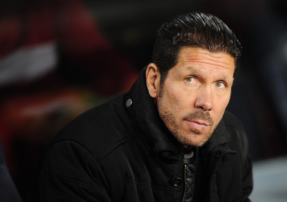 Atletico's coach Diego Simeone waits for the start of a first leg quarterfinal Champions League soccer match between Barcelona and Atletico Madrid at the Camp Nou stadium in Barcelona, Spain, Tuesday April 1, 2014. (AP Photo/Manu Fernandez)
