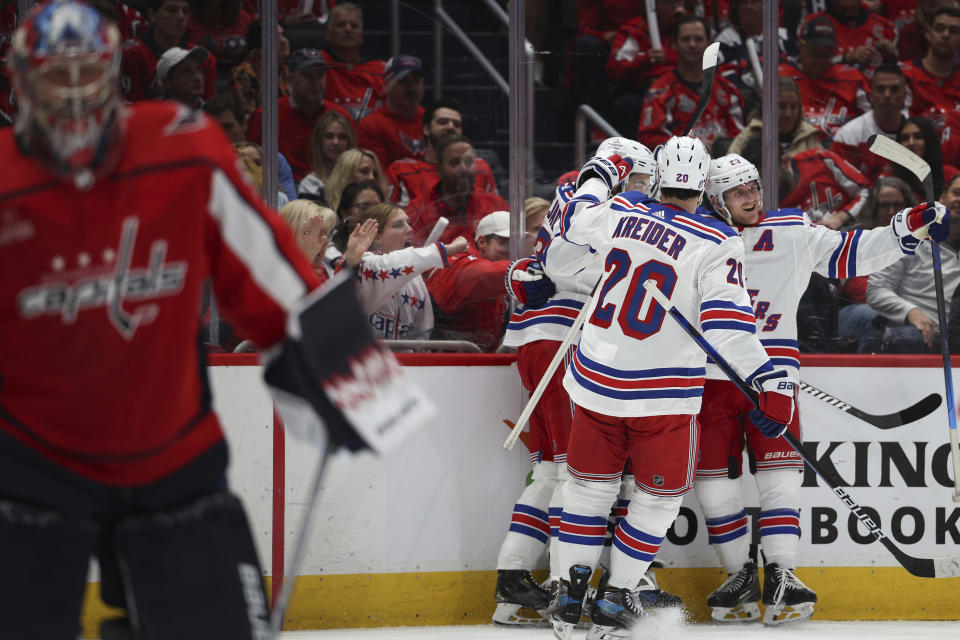 New York Rangers defenseman Adam Fox (23) celebrates with teammates after a goal against the Washington Nationals by center Vincent Trocheck (16) during the second period in Game 3 of an NHL hockey Stanley Cup first-round playoff series, Friday, April 26, 2024, in Washington. (AP Photo/Tom Brenner)