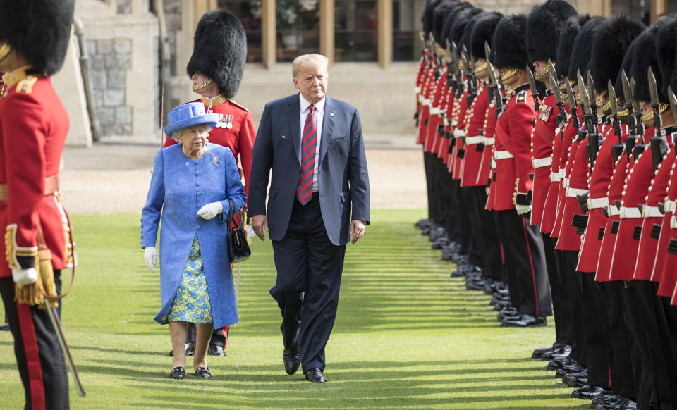 WINDSOR, ENGLAND - JULY 13:  U.S. President Donald Trump and Britain's Queen Elizabeth II inspect a Guard of Honour, formed of the Coldstream Guards at Windsor Castle on July 13, 2018 in Windsor, England.  Her Majesty welcomed the President and Mrs Trump at the dais in the Quadrangle of the Castle. A Guard of Honour, formed of the Coldstream Guards, gave a Royal Salute and the US National Anthem was played. The Queen and the President inspected the Guard of Honour before watching the military march past. The President and First Lady then joined Her Majesty for tea at the Castle.  (Photo by Richard Pohle  - WPA Pool/Getty Images)