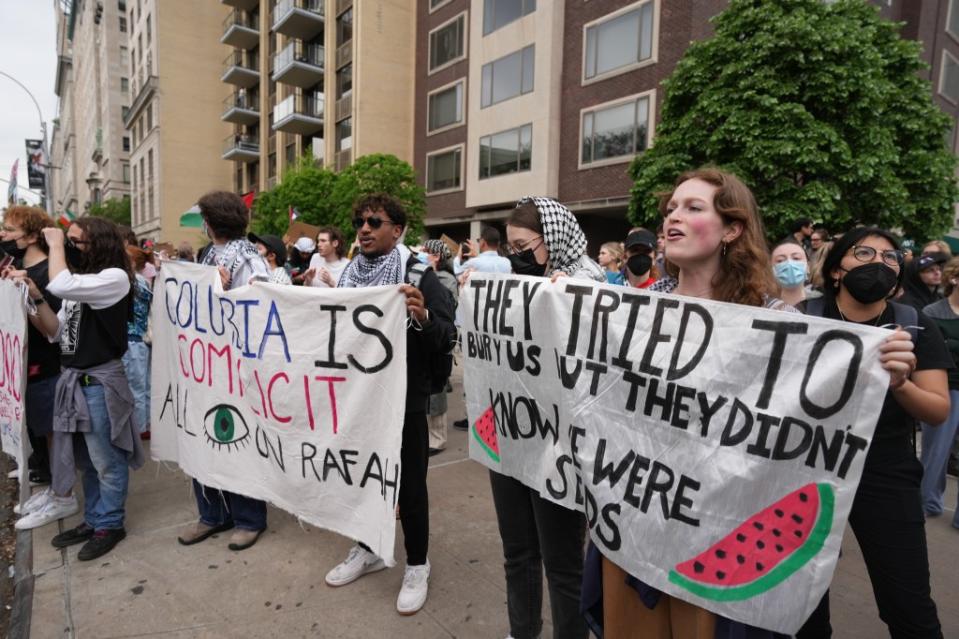 Anti-Israel protesters holding up banners at the Met Gala. James Keivom