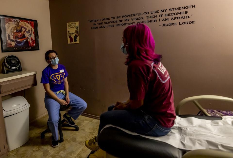 A female doctor, left, discusses options with a female patient after an ultrasound confirmed her pregnancy.