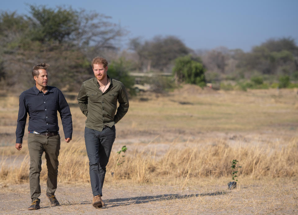 Prince Harry looked dapper as he styled his forest green shirt with a pair of navy chinos and tan desert boots in Botswana. [Photo: Getty Images]